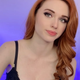 Amouranth stares into the camera with a tired smile on her face.